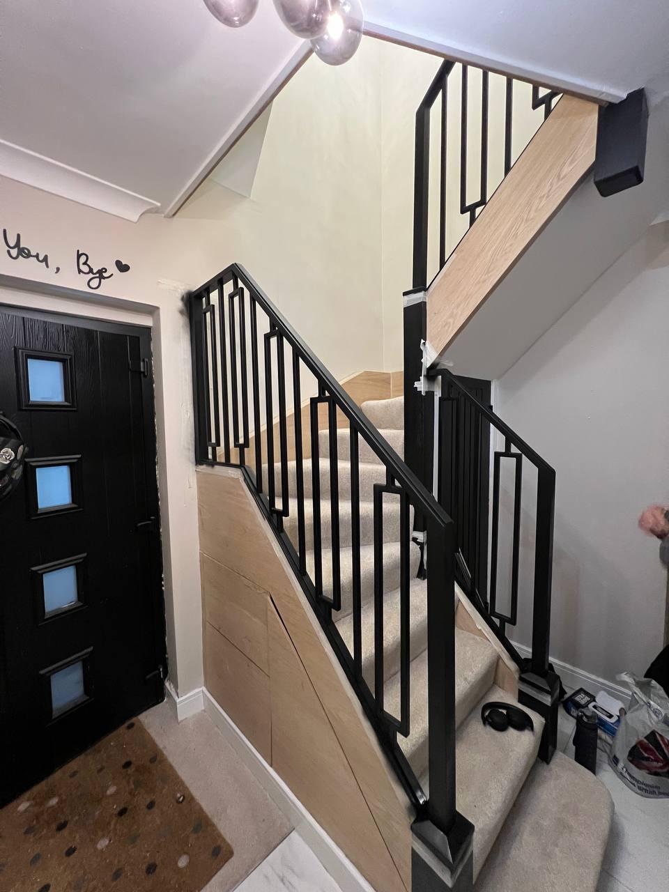 Geometric black balustrade continuing around multiple staircase flights